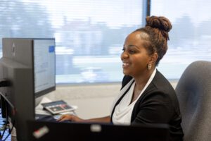 Transportation and Logistics team member working on a computer.