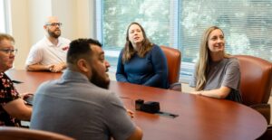 BRC conference table with staff in a meeting discussing business accounting services at BRC