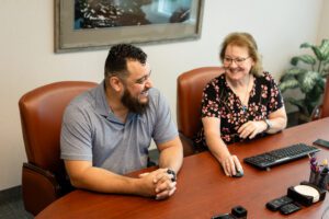 Client and BRC CPA Advisor sitting at conference table discussing affordable housing industry services including assurance, tax and advisory services.